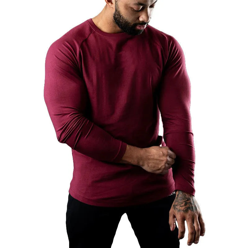 Man wearing a grey long sleeve cotton sports t-shirt with a round neck.