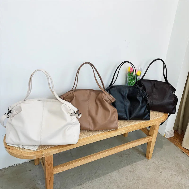 Soft surface PU leather messenger tote bag in a horizontal square shape with an adjustable shoulder strap.