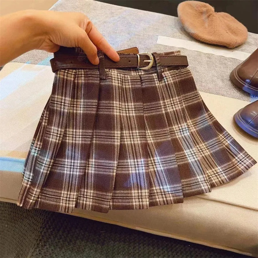 Girls cotton plaid pleated A-line skirt on a hanger, showing its length and pattern.