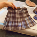 Girls cotton plaid pleated A-line skirt on a hanger, showing its length and pattern.