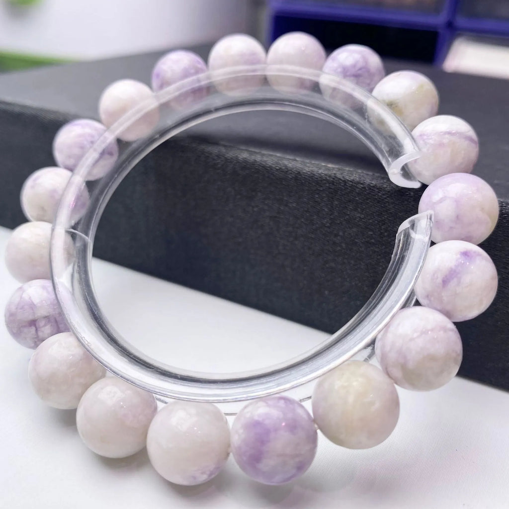 Close-up of a women's bracelet with natural purple turquoise beads on a wrist.
