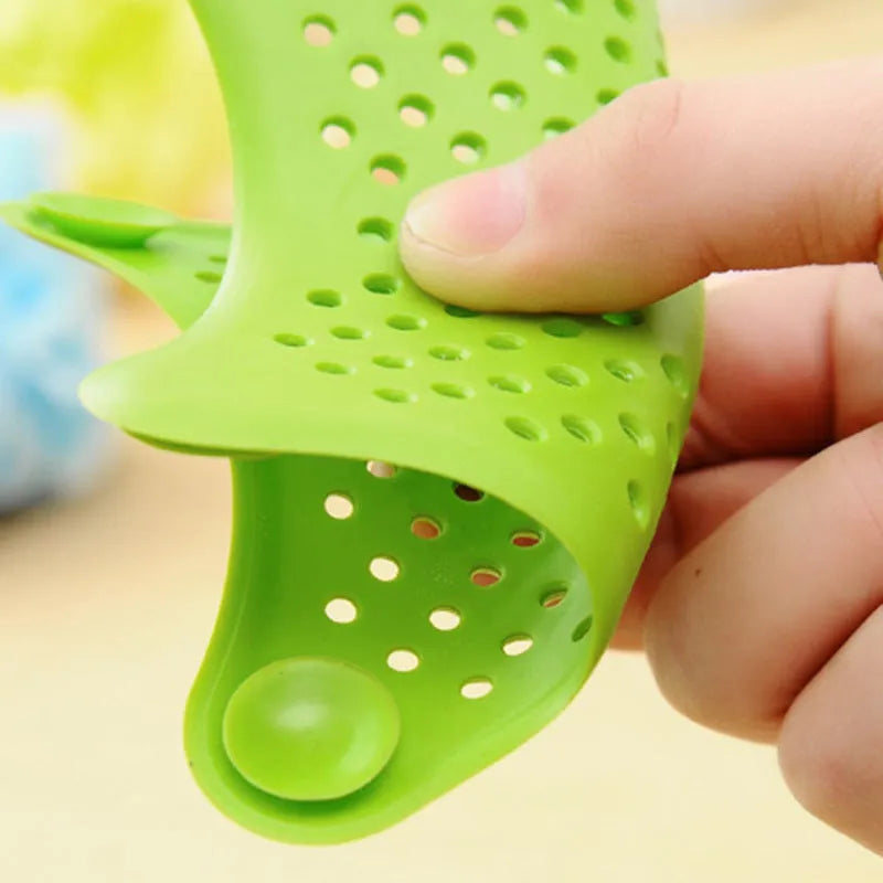 Three silicone starfish-shaped sink drain filters in white blue and green with suction cups