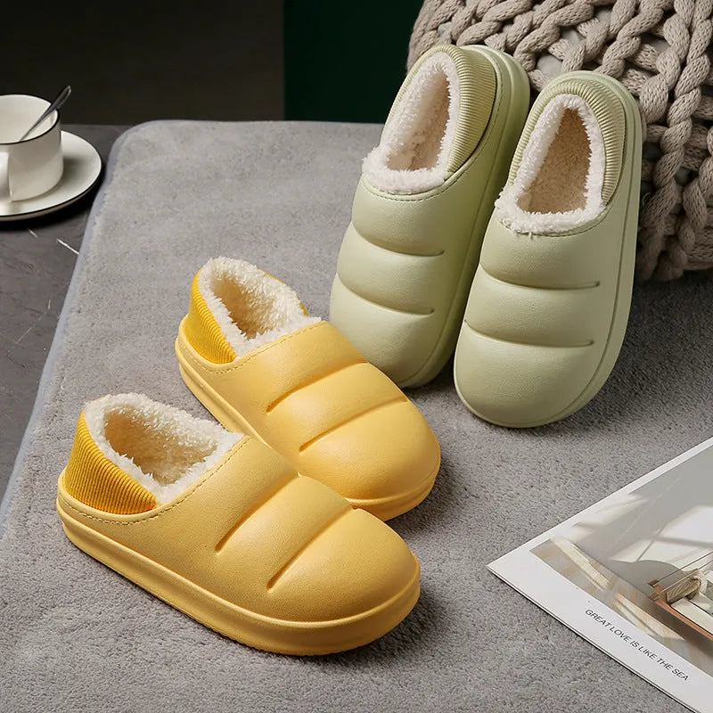 Yellow women's EVA overshoe slippers with plush lining and a textured non-slip sole on a wooden deck.