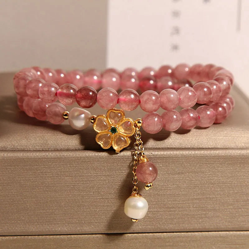 Double ring women's bracelet with strawberry quartz four-leaf clover charms and alloy gemstone details.