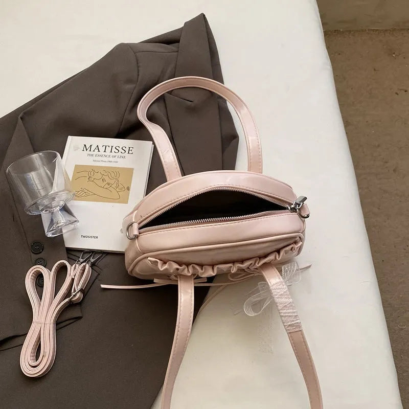 Women's bandage bow handbag in PU leather with phone compartment and sewing thread detail
