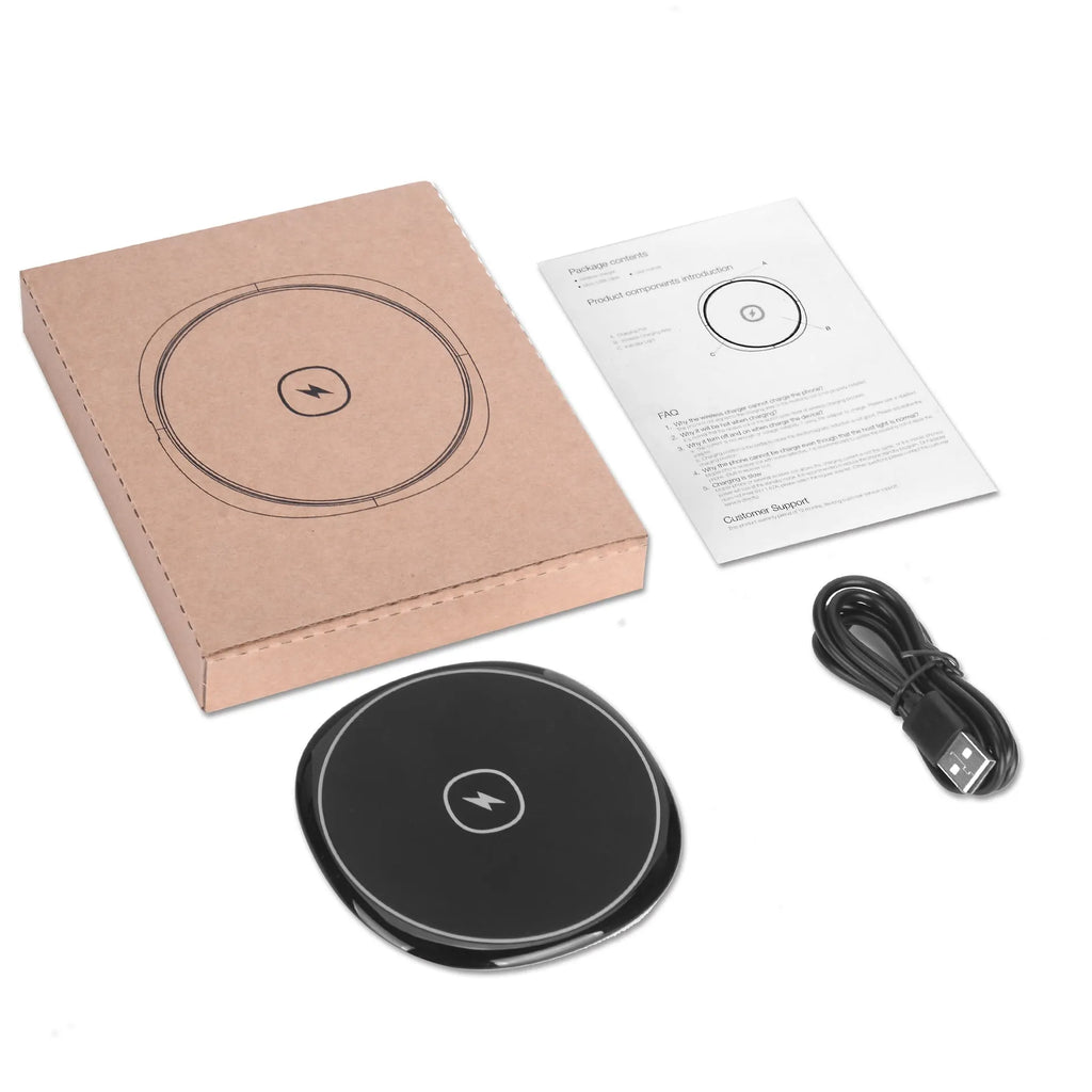 Black 15W fast wireless charger on a desk, glossy surface with indicator light