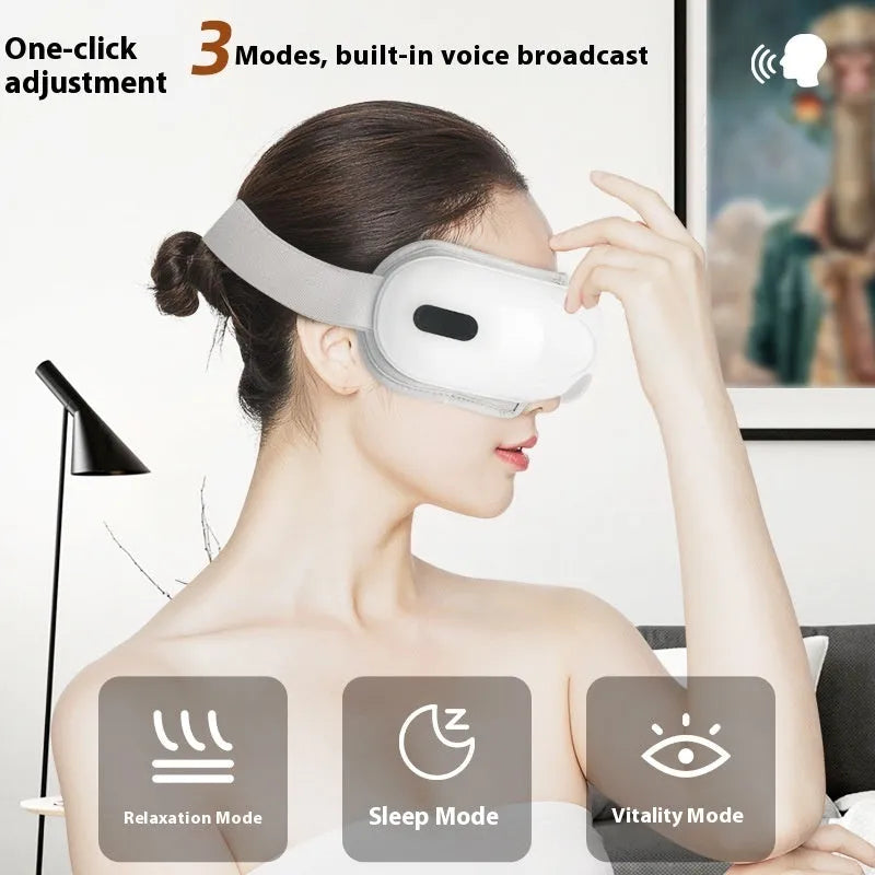 White rechargeable eye massager with airbag compression and hot compress functions on a plain background.