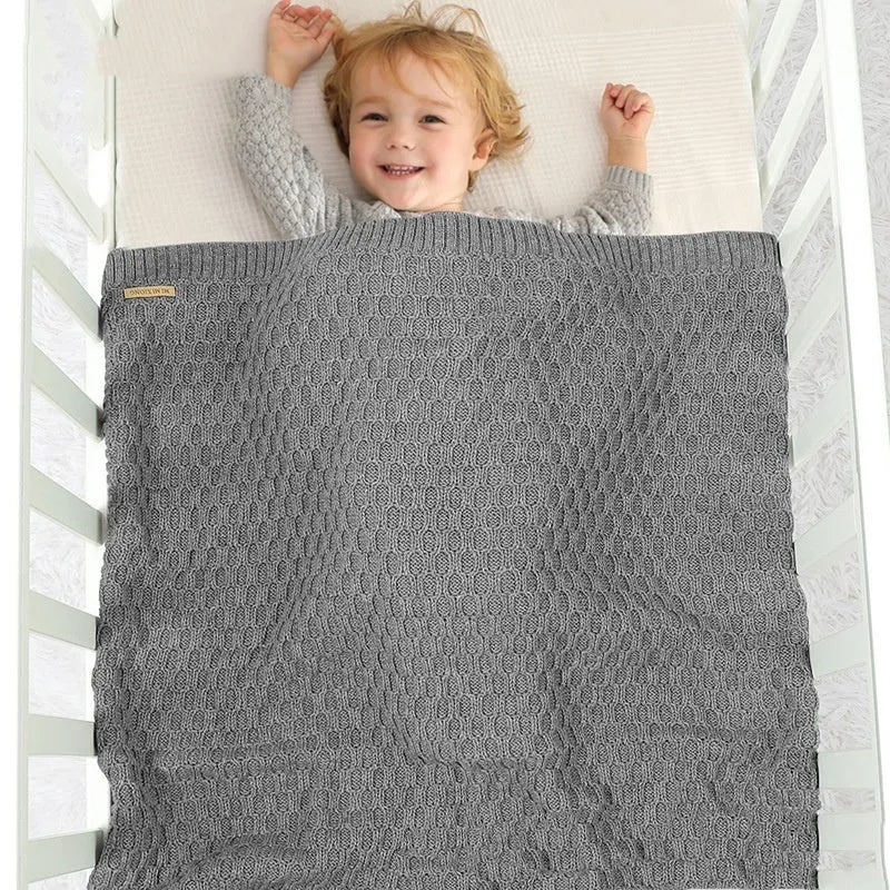 Solid colour acrylic infant hug blanket in light green, showing three-dimensional line texture.
