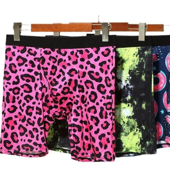 Men's wild leopard print underwear in pink, black and green tie-dye, and doughnut colours on a white background.