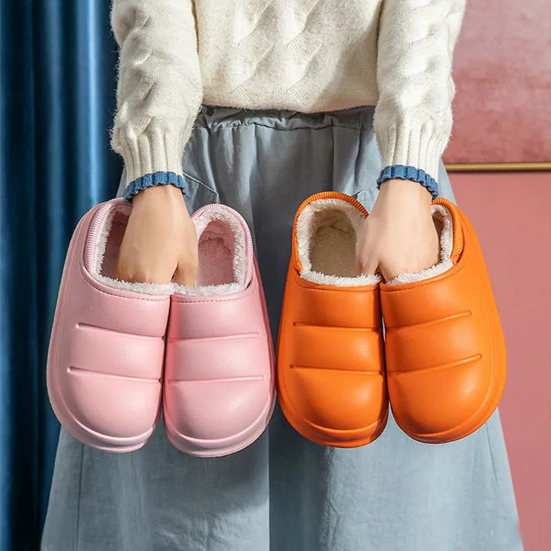 Yellow women's EVA overshoe slippers with plush lining and a textured non-slip sole on a wooden deck.